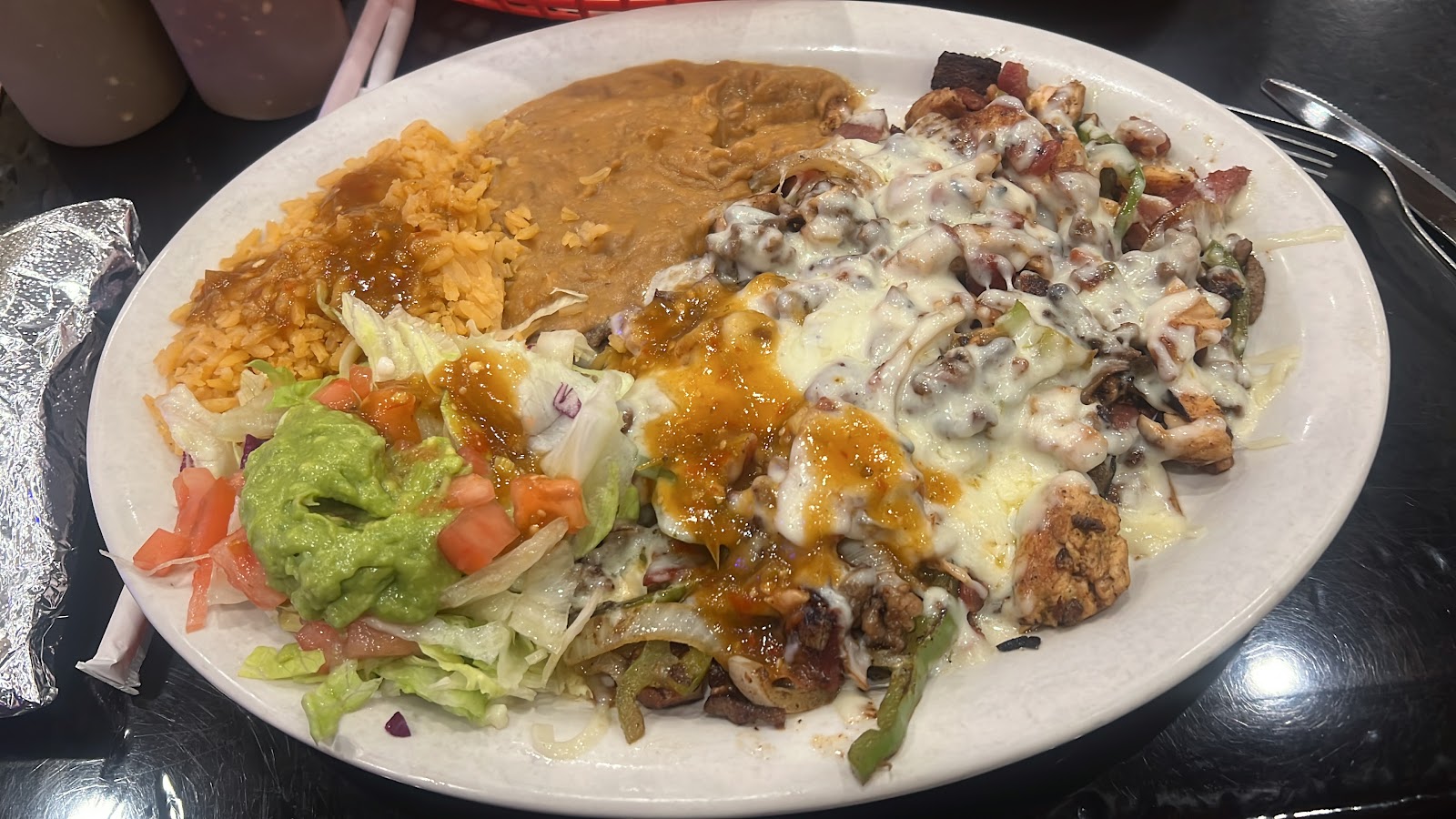 Grilled chicken plate smothered in cheese at El Agave