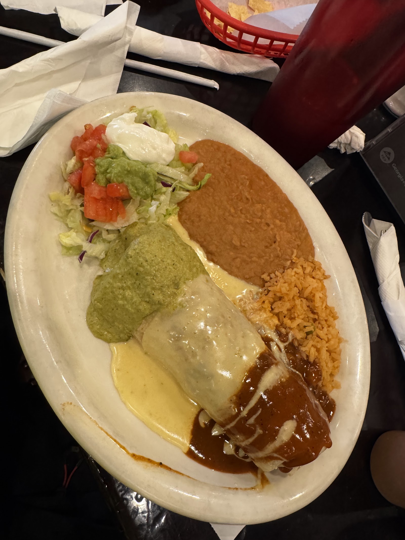 Cheese-smothered burrito plate with rice and beans at El Agave
